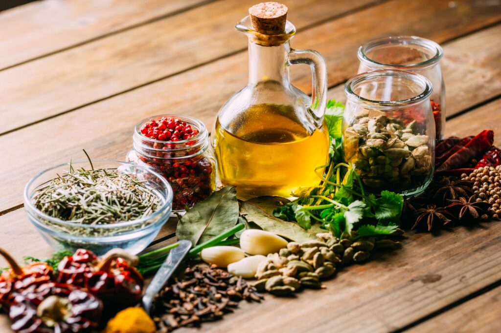 Spices and oil on table